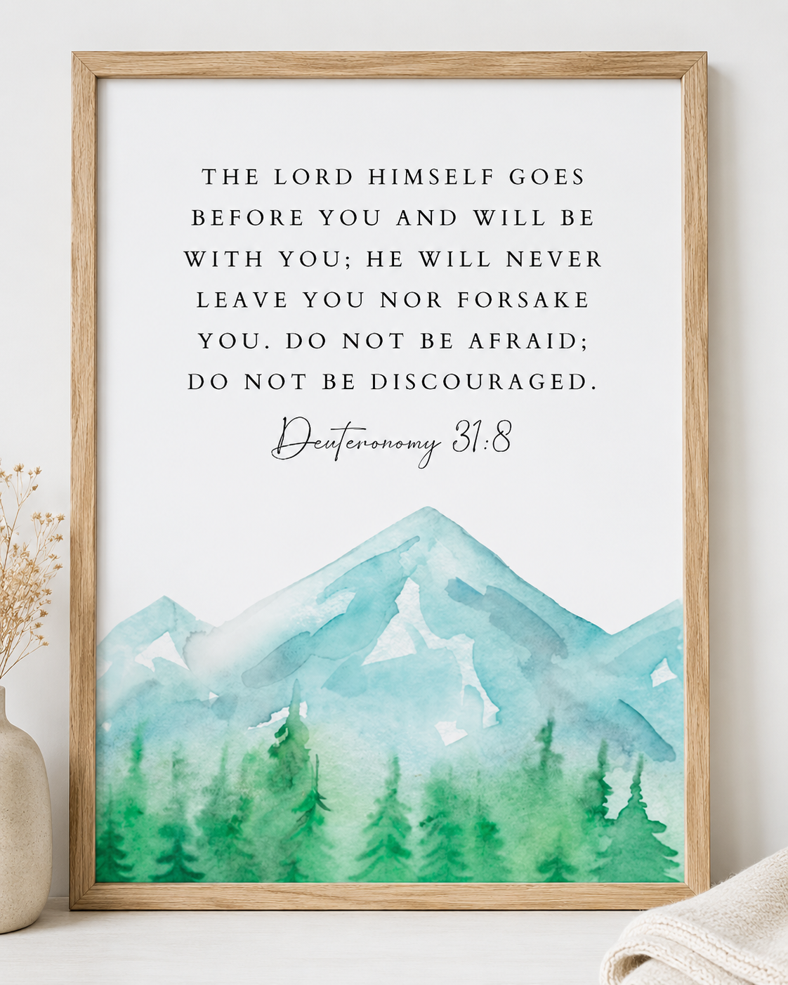 Close-up of Deuteronomy 31:8 wall art print in a wood frame showing the watercolor mountain design and full verse text