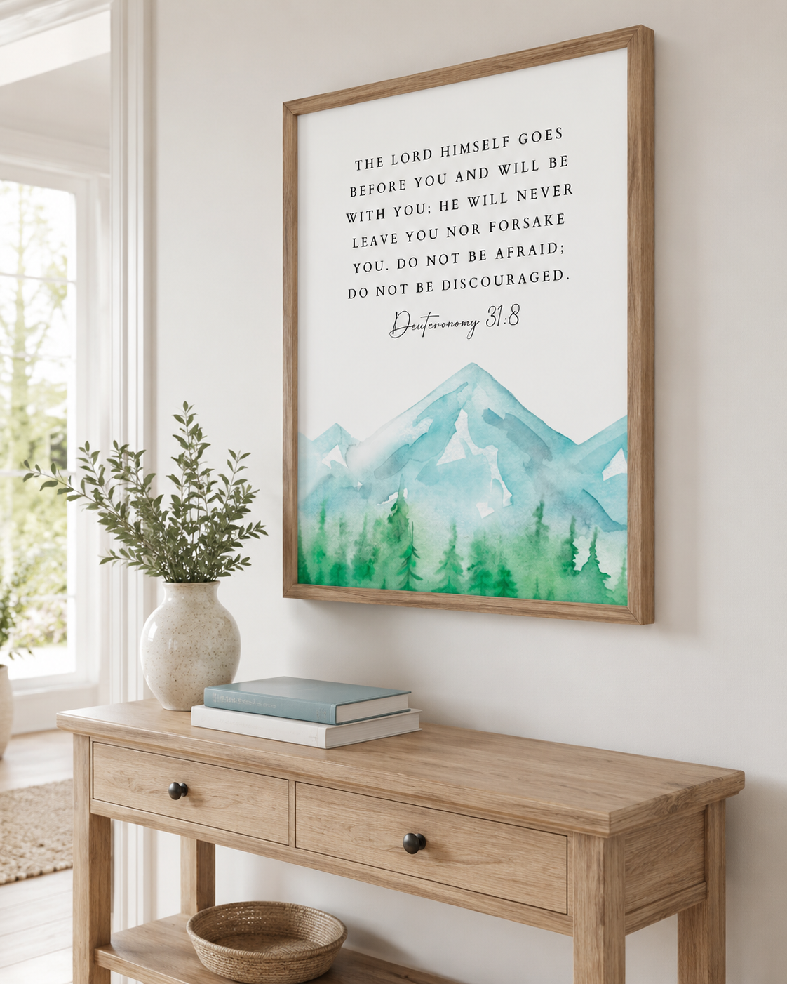 Framed Deuteronomy 31:8 wall art print on a console table near an entryway