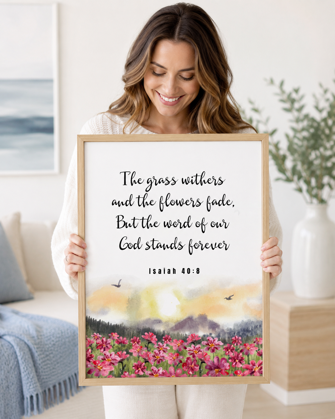 Woman holding a framed Isaiah 40:8 Bible verse print at home