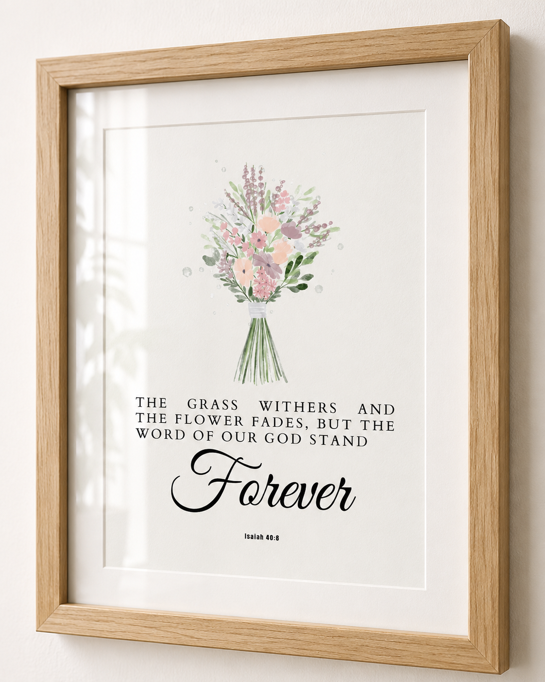 Close-up of Isaiah 40:8 wall art print in a wood frame showing the watercolor floral design