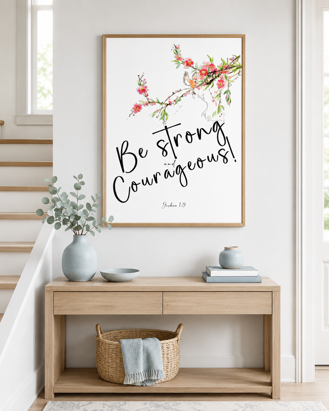 Framed Joshua 1:9 floral wall art print on a console table near an entryway