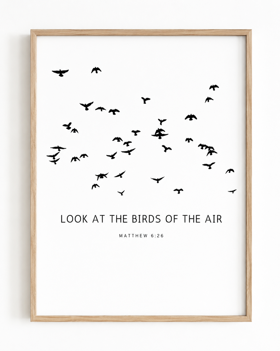 Close-up of Matthew 6:26 wall art print in a wood frame showing the minimalist bird design