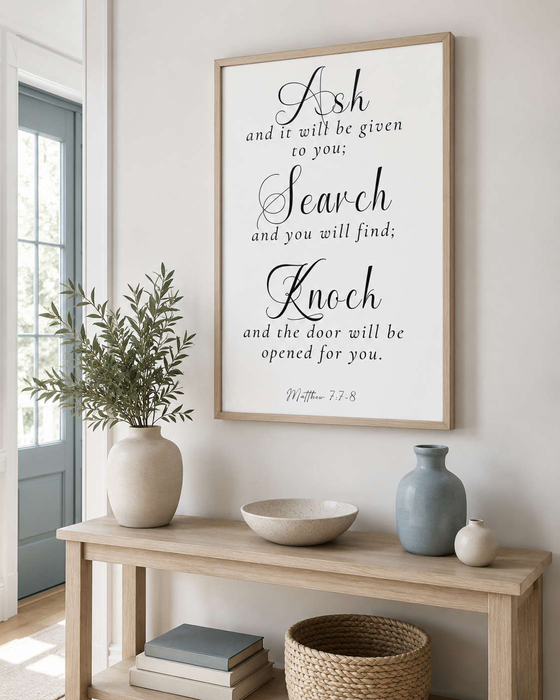 Framed Matthew 7:7-8 wall art print on a console table near an entryway
