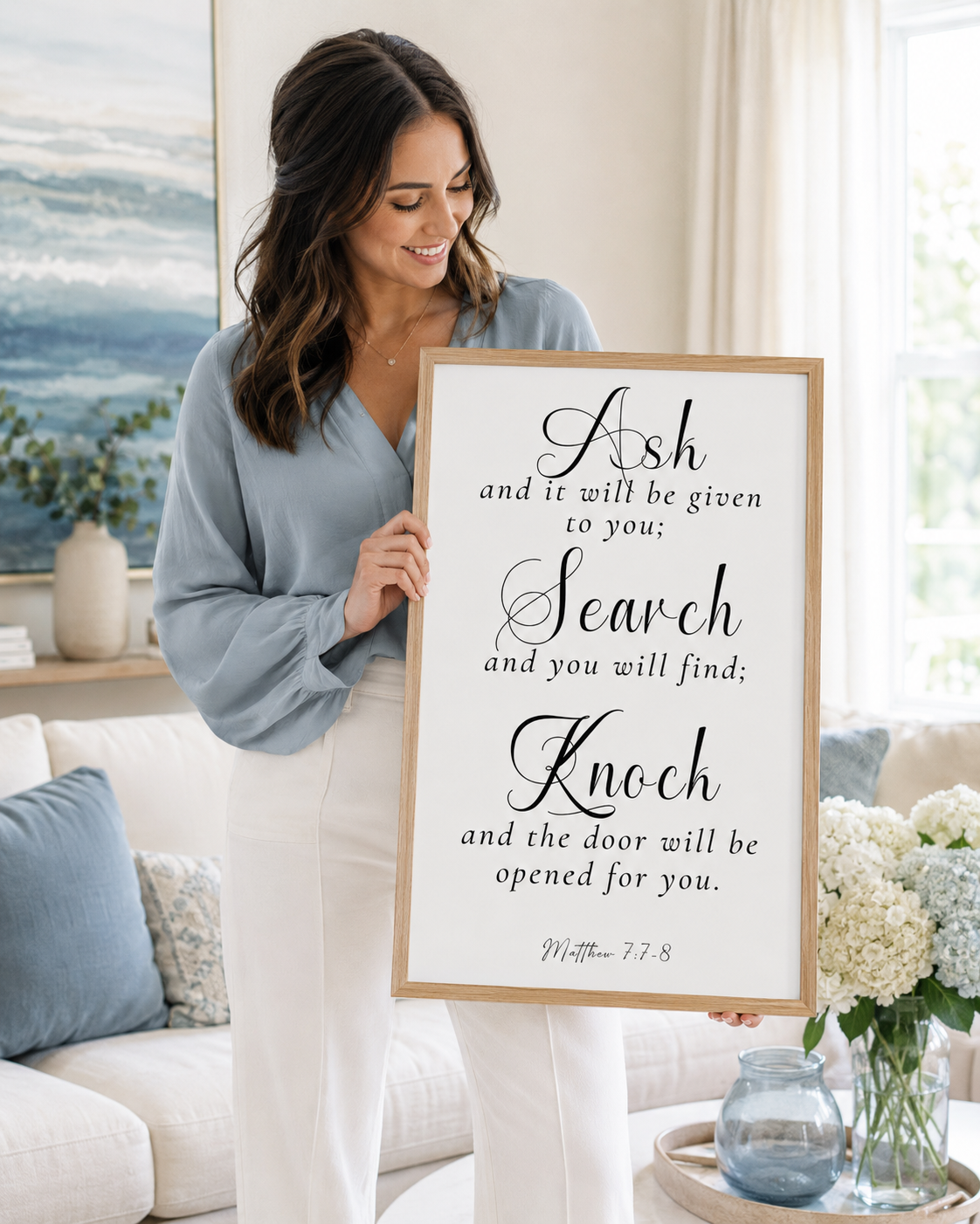 Woman holding a framed Matthew 7:7-8 Bible verse print at home