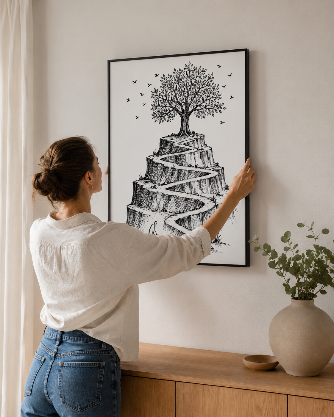 Woman hanging the mustard seed parable sketch above a wood console