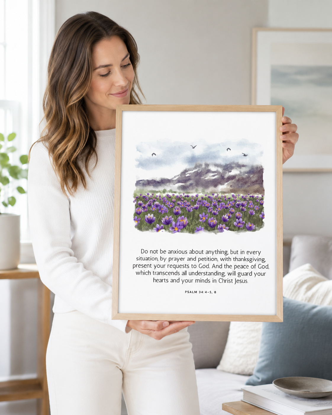 Woman holding a framed Philippians 4:6-7 Bible verse print at home