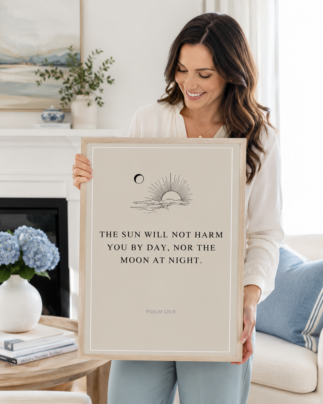 Woman holding a framed Psalm 121:6 Bible verse print at home