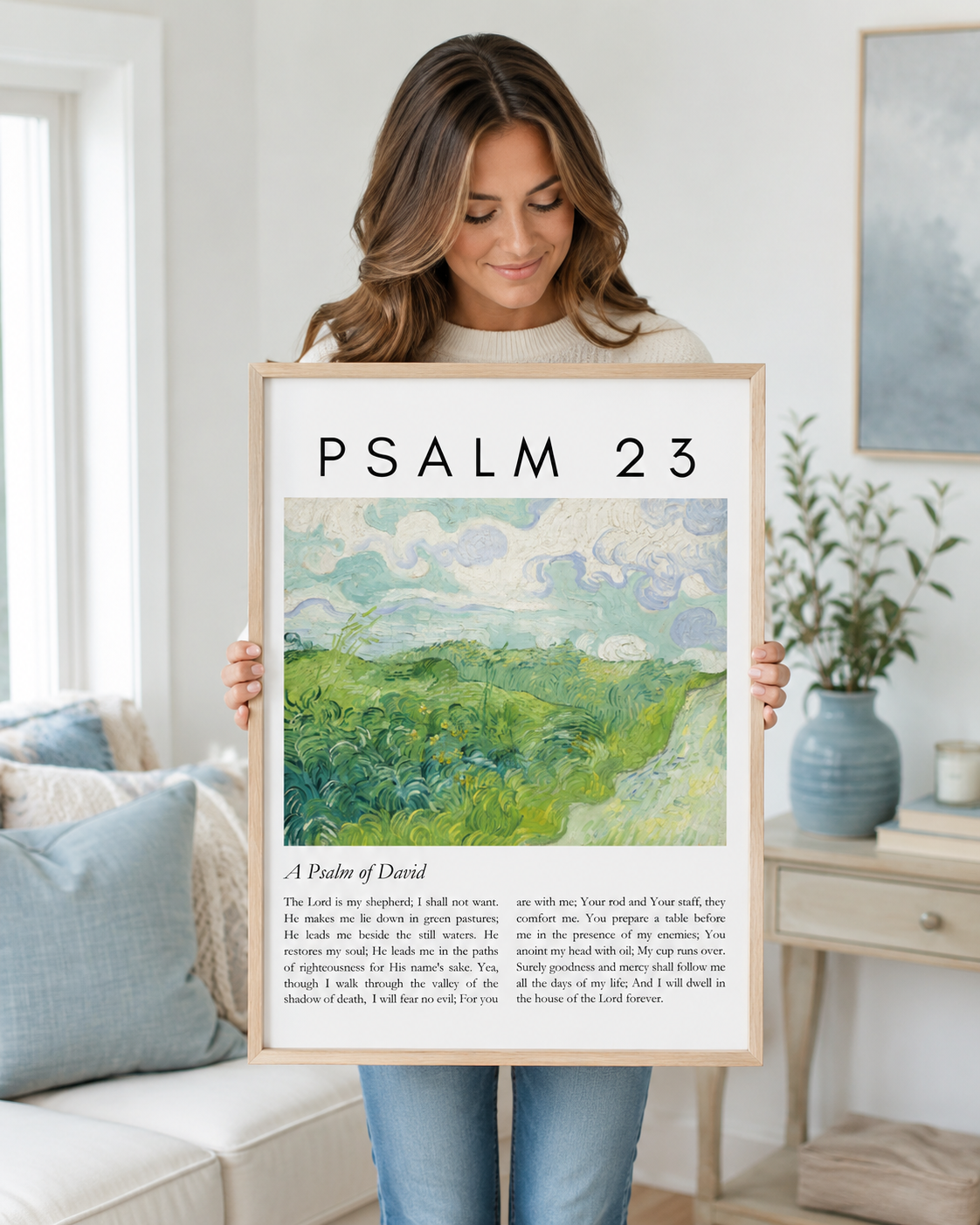 Woman holding a framed Psalm 23:1-4 Bible verse print at home