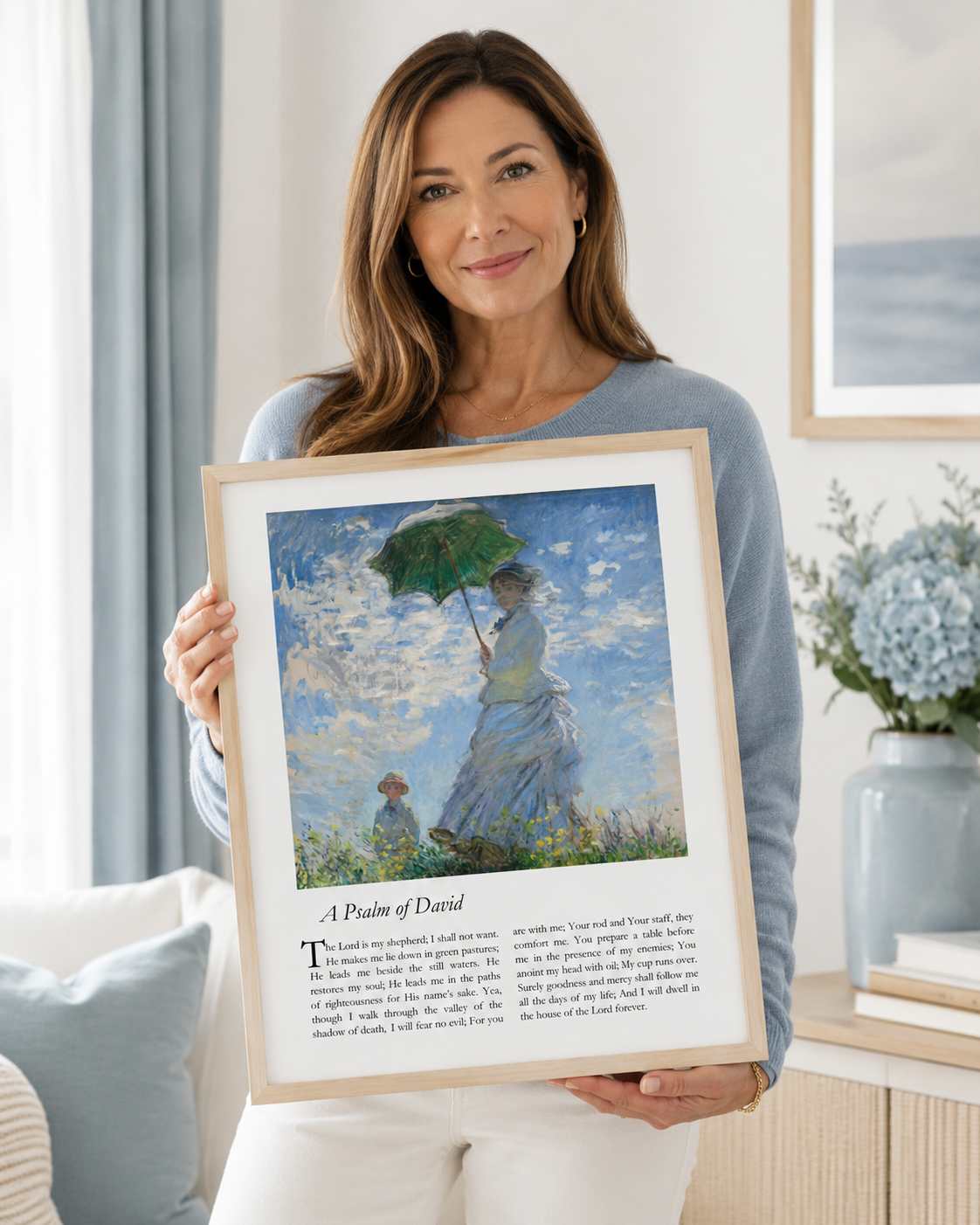 Woman holding a framed Psalm 23 art print with the complete psalm text