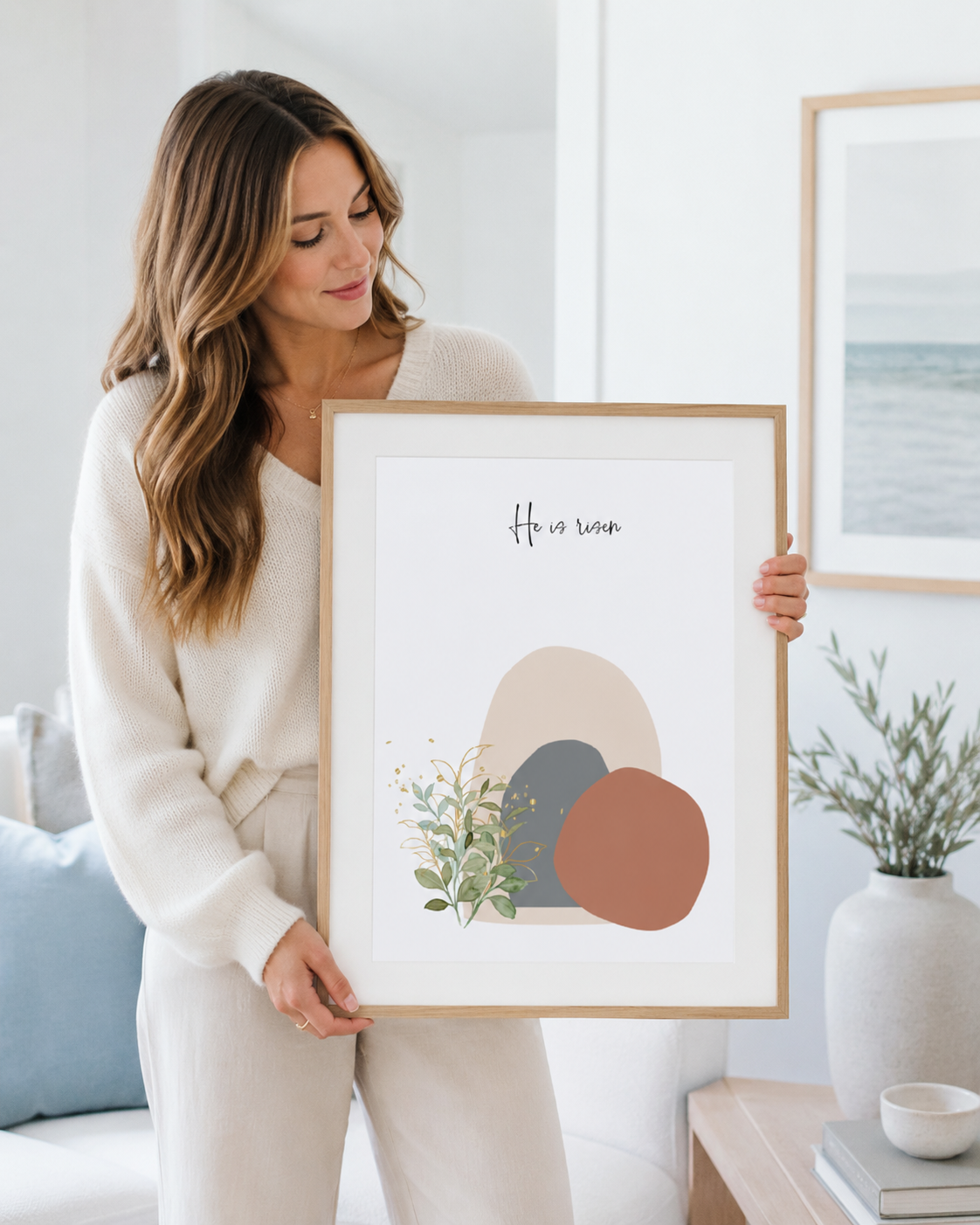 Woman holding a framed He Is Risen Easter resurrection print as a gift